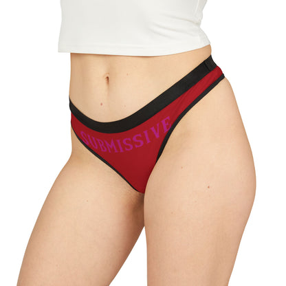 Chic women's thong in red worn on a model, highlighting the playful "SUBMISSIVE" text and modern design for a bold statement.