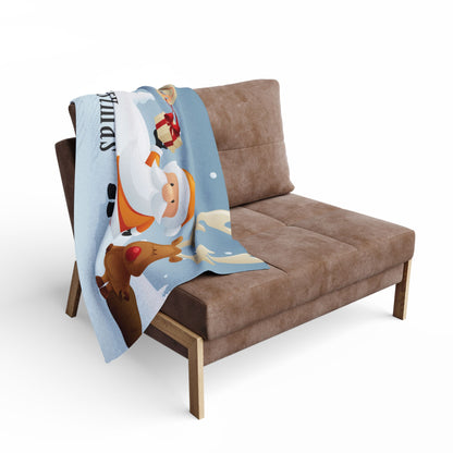 Decorative and Warm Christmas Arctic Fleece Blanket draped over a stylish sofa, enhancing the cosy atmosphere of the living space during the festive season.