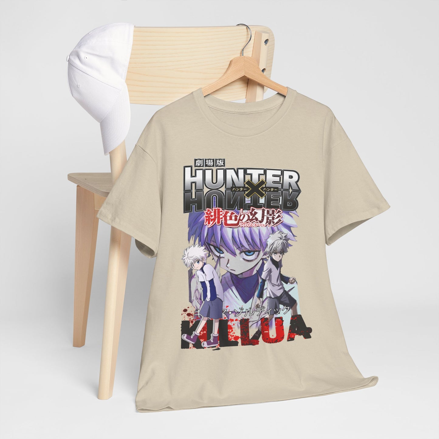 Stylish beige Hunter x Hunter T-shirt artistically draped on a chair with a complementary cap, showcasing the iconic characters Killua and Gon for discerning anime enthusiasts.