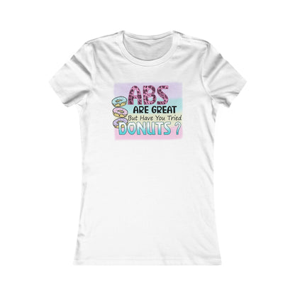 Elegant white women's T-shirt featuring a whimsical graphic that reads 'ABS ARE GREAT But Have You Tried DONUTS?', adorned with colourful donut illustrations, perfect for a fun yet classy look.