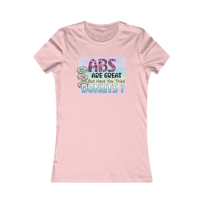 Refined pink women's T-shirt featuring an imaginative design with 'ABS ARE GREAT But Have You Tried DONUTS?' text and colourful donut images, ideal for a fashionable statement in everyday wear.