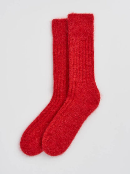 Elegant close-up of luxury alpaca bed socks, highlighting the plush feel and refined design for ultimate comfort.