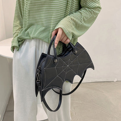 Fashionable detail of a black Halloween Spider Web Shape Shoulder Bag, showcasing its sophisticated batgirl design, perfect for seasonal celebrations.