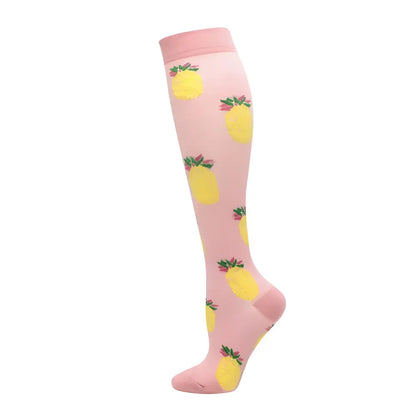 Women's Knee Length Compression Travel Socks featuring vibrant pineapple designs on a pink background, ideal for stylish travel comfort and circulation.