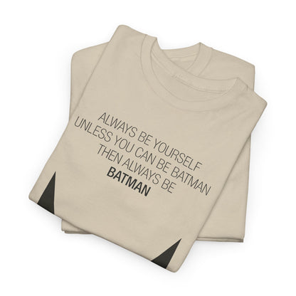 Always Be Yourself – Luxurious beige Graphic T-Shirt folded neatly, featuring a minimalist Batman logo, perfect for stylish individuals.