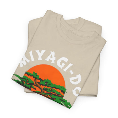 Luxurious stack of beige t-shirts featuring the Miyagi-Do Karate graphic, elegantly designed with a sunset and tree motif for stylish layering.