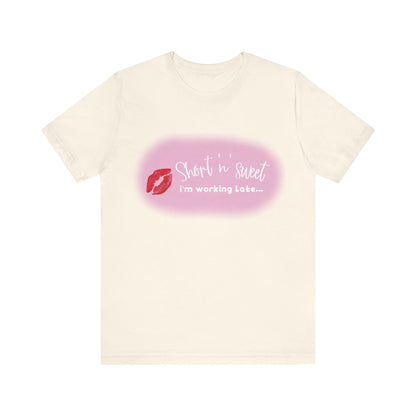 Sabrina Carpenter Inspired Unisex Short Sleeve Tee featuring a vibrant lipstick print, elegantly displayed against a creamy background.