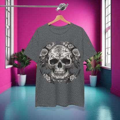 Stylish display of the Skulls and Roses Cotton Tee, unisex graphic shirt, hanging against a vibrant pink background, showcasing intricate skull and rose design.