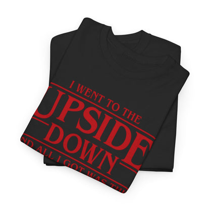 Stylish Stranger Things Unisex Graphic Tee folded, highlighting the striking red print 'I WENT TO THE UPSIDE DOWN AND ALL I GOT WAS THIS STRANGE T-SHIRT', a perfect blend of humour and high-quality design.