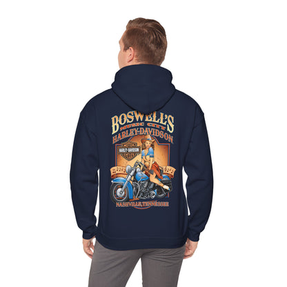 Man wearing a vintage Harley-Davidson hoodie, showcasing a striking pin-up illustration and the brand name 'Boswell's Music City' on the back, embodying a blend of classic motorcycle culture and musical heritage in Nashville.
