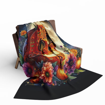 Elegant Decorative and Warm Halloween Spooky Arctic Fleece Blanket artfully draped over a chair, featuring a stunning pumpkin skull surrounded by florals, creating an inviting and festive atmosphere.