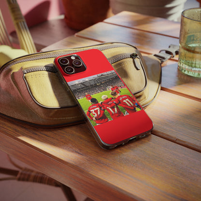 Manchester United Mainoo Garnach Hojlund Soft Phone Case elegantly placed on a wooden table, capturing the essence of sports luxury.