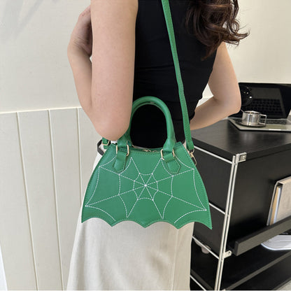 Vibrant green Halloween Spider Web Saddle Bag styled as a crossbody, illustrating unique and luxurious spider web detail, a standout accessory for any occasion.