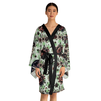 Floral Kimono Robe depicting a woman wearing a luxurious designer lounge wear, showcasing a stunning floral pattern, black trim, and elegant bell sleeves, perfect for boho chic aesthetics.