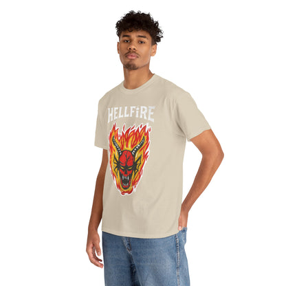 Stylish male model wearing a beige Hellfire Club graphic t-shirt adorned with a fierce demon head and vibrant flames, exuding urban sophistication.
