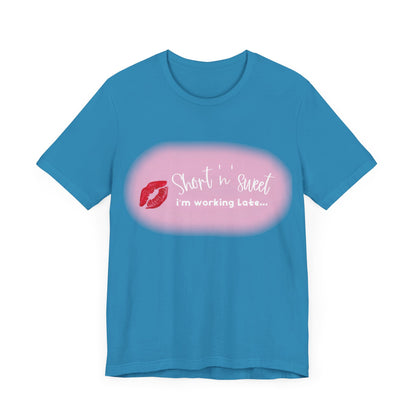 Front view of the bold Sabrina Carpenter Inspired Unisex Short Sleeve Tee in blue, adorned with a vibrant lipstick motif and whimsical text for a trendy look.