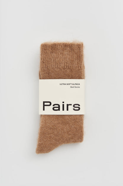 Close-up of ultra soft alpaca bed socks, highlighting plush material and intricate stitching for a touch of luxury.