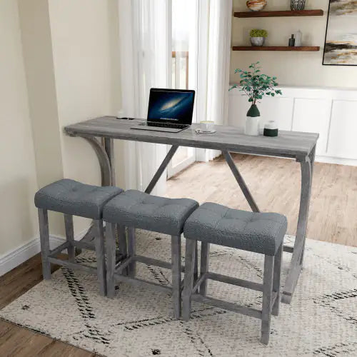 Luxurious Apex Artisan Bar and workstation featuring a sleek solid wood table and three stylish designer stools upholstered in light grey, accompanied by a laptop and decorative plant.