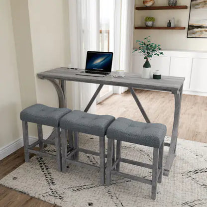 Luxurious Apex Artisan Bar and workstation featuring a sleek solid wood table and three stylish designer stools upholstered in light grey, accompanied by a laptop and decorative plant.