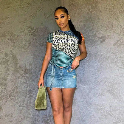 Model wearing Sweet Legend Women's Vibrant Print Cropped Tee by Dazzling Dreams Studio, styled with high-waisted jeans for a chic look.