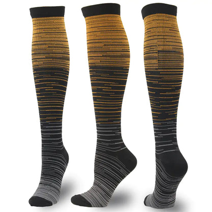 Dazzling Dreams Studio Men's and Women's activewear Flightwear Compression Stockings in a stylish gradient design featuring shades of gold and black, perfect for enhancing performance during athletic activities.