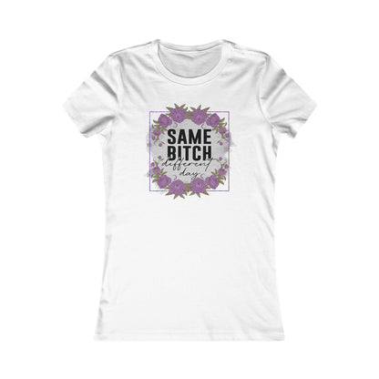 Luxurious women's t-shirt featuring an empowering graphic design that reads 'Same Bitch Different Day', surrounded by elegant floral accents in light purple and deep greens, all framed with a shimmering purple glitter border.