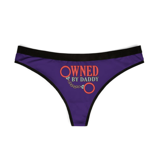 Elegant purple thong with black trim, showcasing a striking 'Owned by Daddy' graphic, ideal for cheeky gifting on special occasions.
