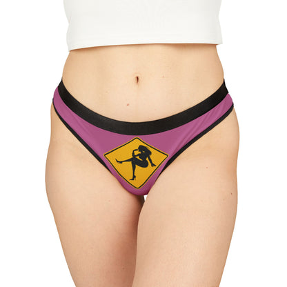 Luxury women's thong featuring a playful graphic design, showcasing a symbol of flirtation on a pink background, perfect for romantic occasions.