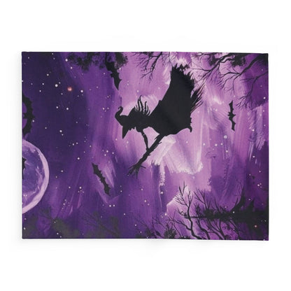 Decorative and Warm Halloween Spooky Arctic Fleece Blanket illustrating a dynamic witch in flight amidst a mystical purple backdrop, featuring a full moon and bats for added enchantment.