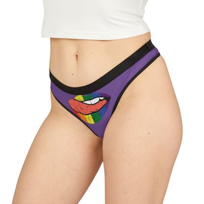 Model showcasing a vibrant purple thong adorned with a striking graphic of rainbow lips, embodying a fun and flirty spirit.