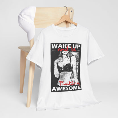 Chic graphic t-shirt laid on a chair with a baseball cap, featuring bold lettering 'WAKE UP and be' and 'Fucking AWESOME', ideal for modern urban environments.
