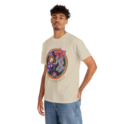 Contemporary male model wearing a stylish graphic tee with a whimsical wizard girl and a charming creature, elegantly displaying 'WILL THE WISE', ideal for trendsetters and fantasy enthusiasts.