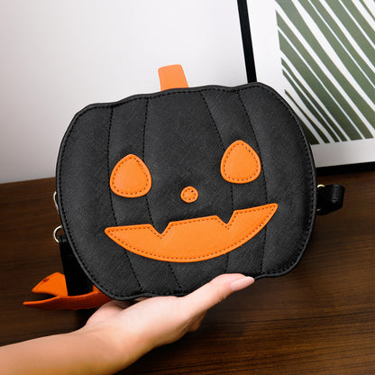 2023 Halloween Bags Funny Pumpkin Cartoon Shoulder Crossbody Bag being held gracefully, showcasing its playful black pumpkin design with vibrant orange accents.