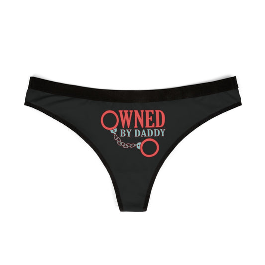 Elegant black women's thong showcasing the slogan 'Owned by Daddy' alongside artistic handcuffs, an alluring addition to intimate apparel.