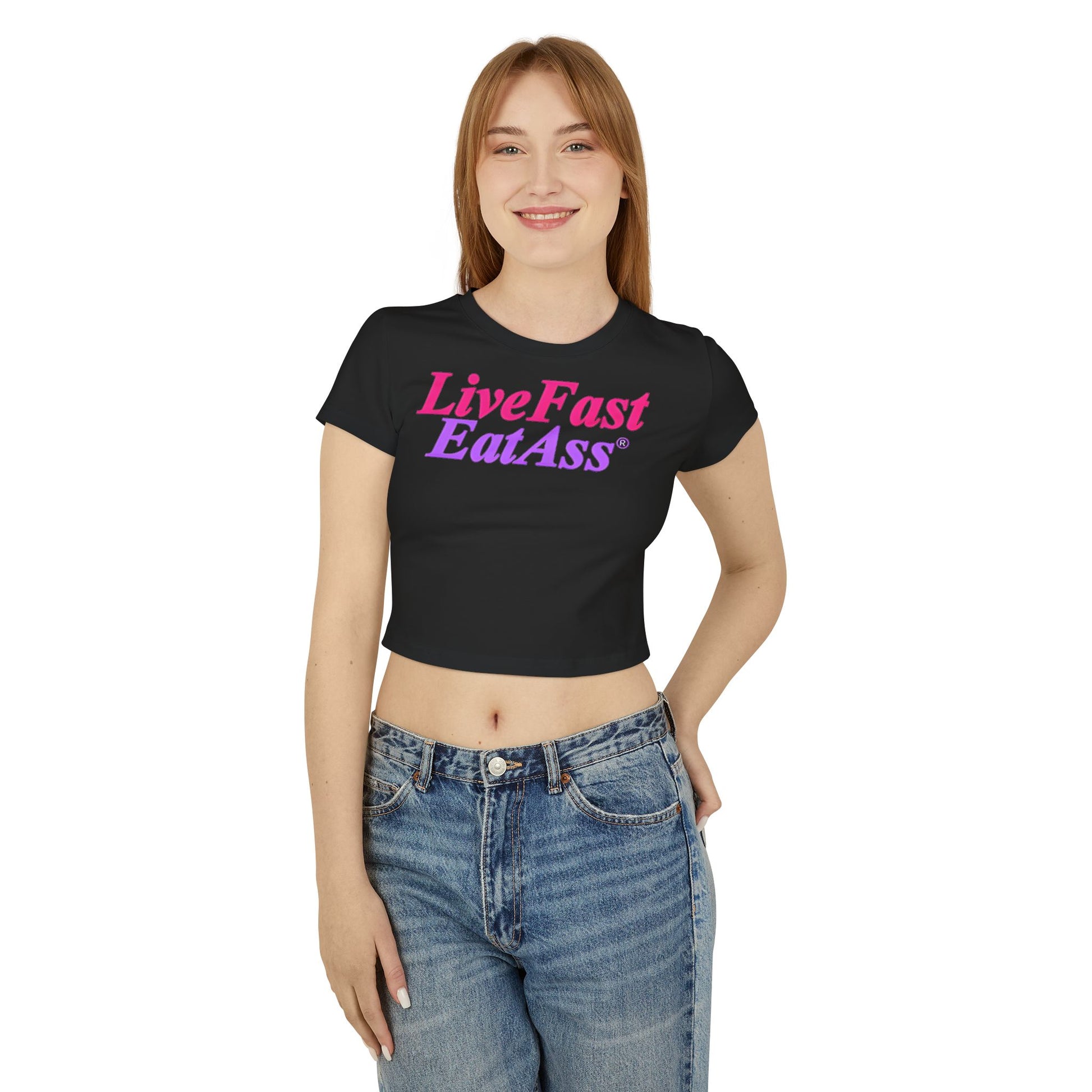 Model wearing the luxurious black cropped t-shirt with 'Live Fast EatAss' emblazoned in vibrant colours, embodying playful elegance for any occasion.