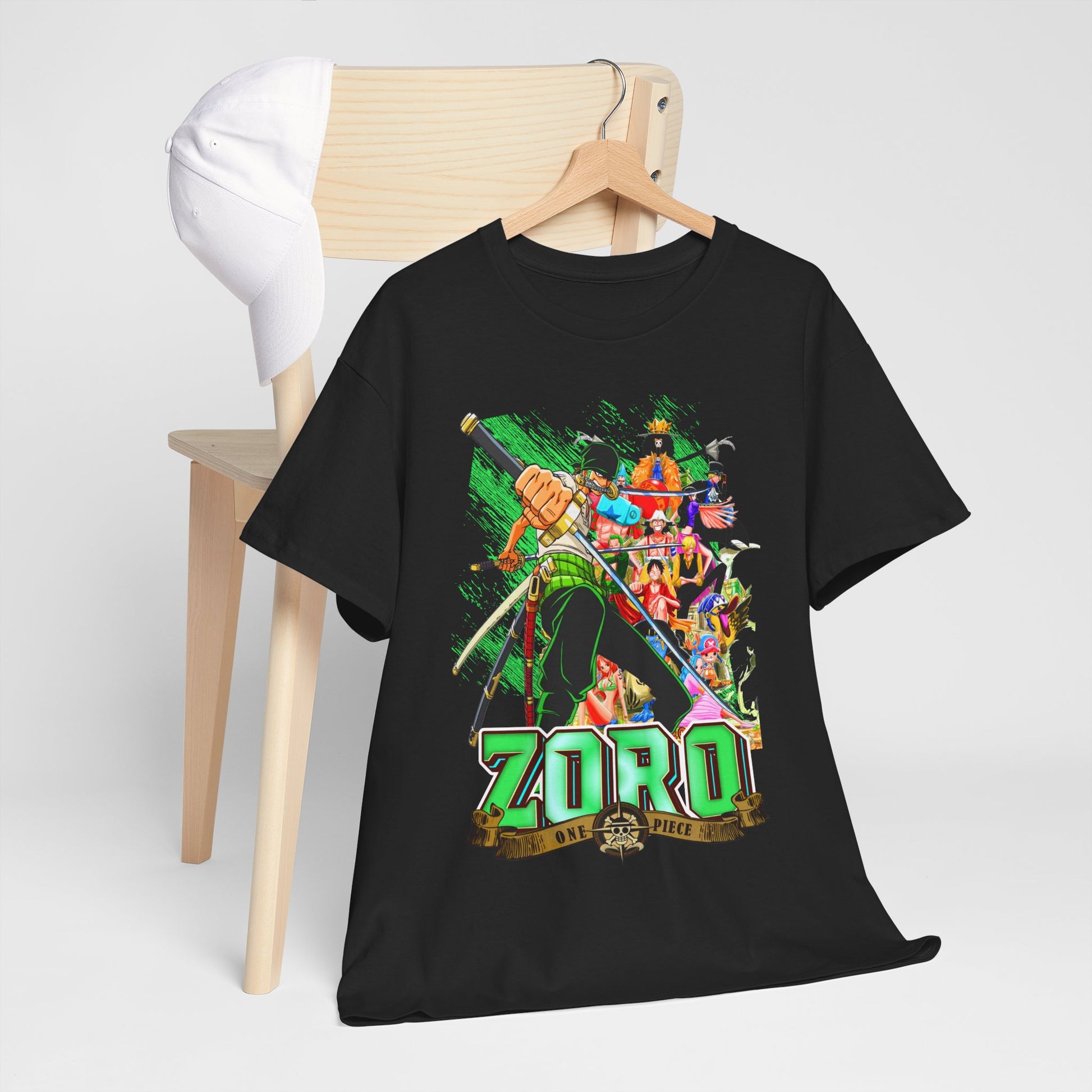 Chic black One Piece Zoro T-shirt on a wooden chair, complemented by a white cap, highlighting the striking design and perfect for casual outings.