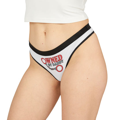 Fashionable thong on a model, featuring a striking 'Owned By Daddy' design, ideal for infusing humour into luxurious lingerie.