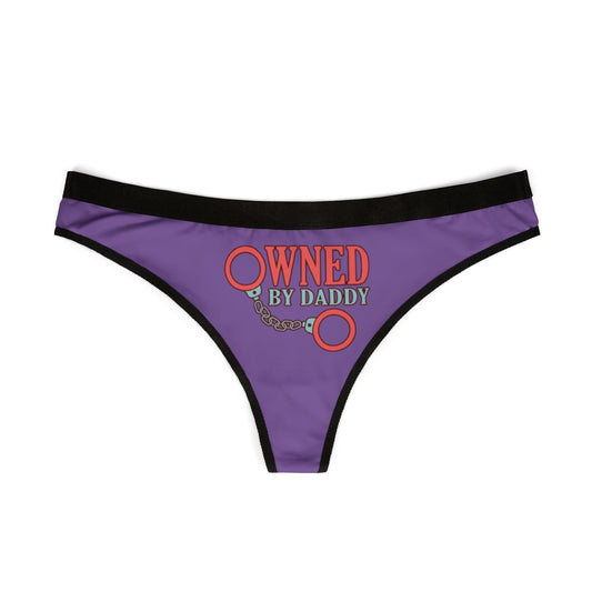 Elegant women's thong showcasing a striking graphic with the phrase 'Owned by Daddy', elegantly printed in red against a deep purple base. Perfect for those looking to blend humour and sophistication in their lingerie.