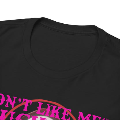 Close-up view of the neckline and shoulder of a luxurious black T-shirt featuring bold pink typography that reads 'DON'T LIKE ME? FK OFF'.