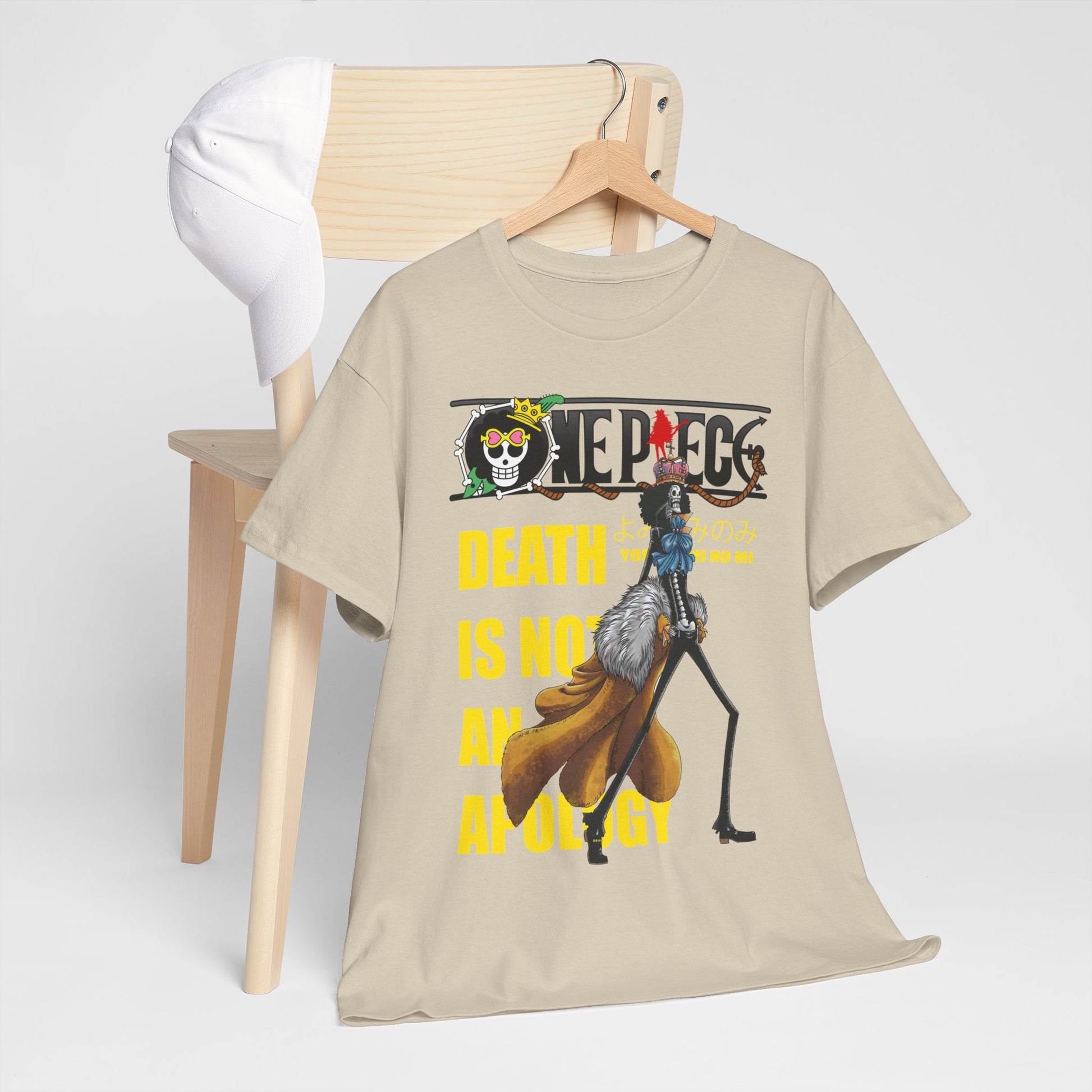 Chic beige graphic tee artistically draped over a chair, adorned with a captivating 'One Piece' design that embodies anime culture and fashion.