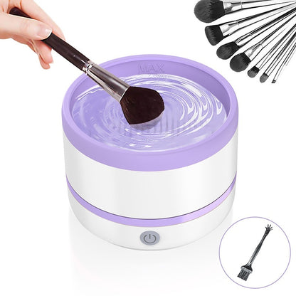 Dazzling Dreams Studio Makeup Brush Automatic Cleaning Device in a sophisticated purple finish, displaying the device in use while effectively cleansing a makeup brush.