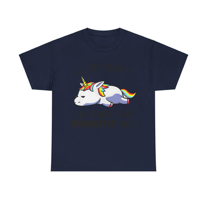 Unicorn Melancholy Graphic Tee displayed on a navy background, featuring a charming cartoon unicorn with a colourful mane and the slogan 'I'LL GET OVER IT I JUST NEED TO BE DRAMATIC FIRST'.