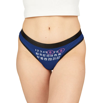 Sophisticated blue thong with a striking playful print of numbers, featuring '6' and '9' accentuated in soft pink circles, embodying luxury and flirtation.
