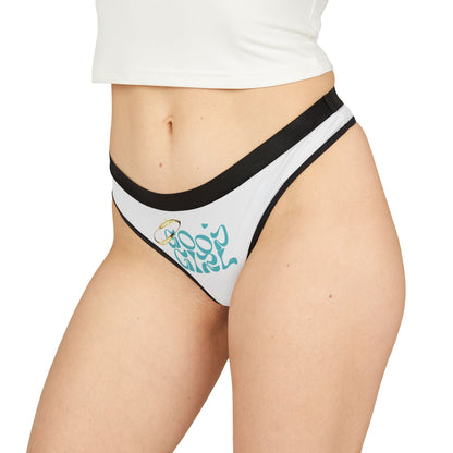 Model showcasing the 'Good Girl' thong panties in white with chic black trim, accentuating curves and radiating confidence.