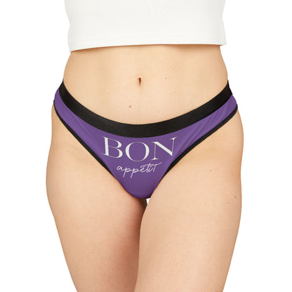 Elegant women’s thong featuring the whimsical phrase 'BON appétit' in a stylish font, set against a rich purple background with sophisticated black trim. Perfect for adding playful charm to intimate wear, this piece is an ideal gift for special occasions.