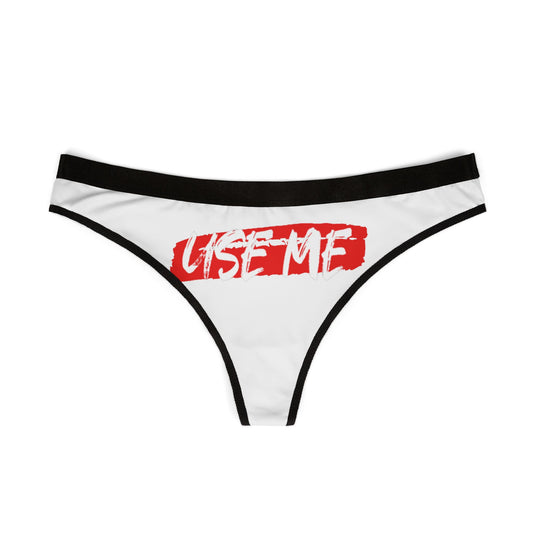 Chic women's thong featuring bold 'USE ME' graphic on a white background, accentuated by a sleek black waistband. Perfect for a playful yet elegant addition to any lingerie collection.