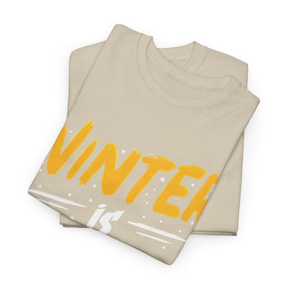 Elegantly folded Winter Is Coming Graphic T-Shirt featuring a striking design with yellow and white lettering on premium beige cotton, ideal for winter fashion.