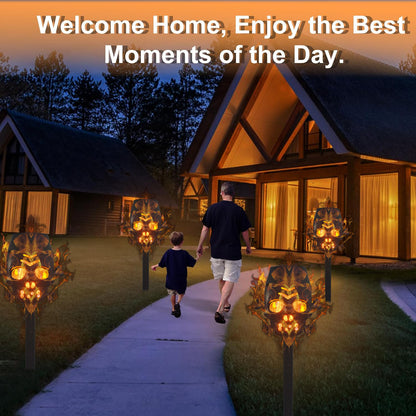 Elegant outdoor scene featuring the Solar Skull Simulation Flame Lamp Halloween Torch, illuminating a pathway with a warm glow, inviting ambiance for festive celebrations.