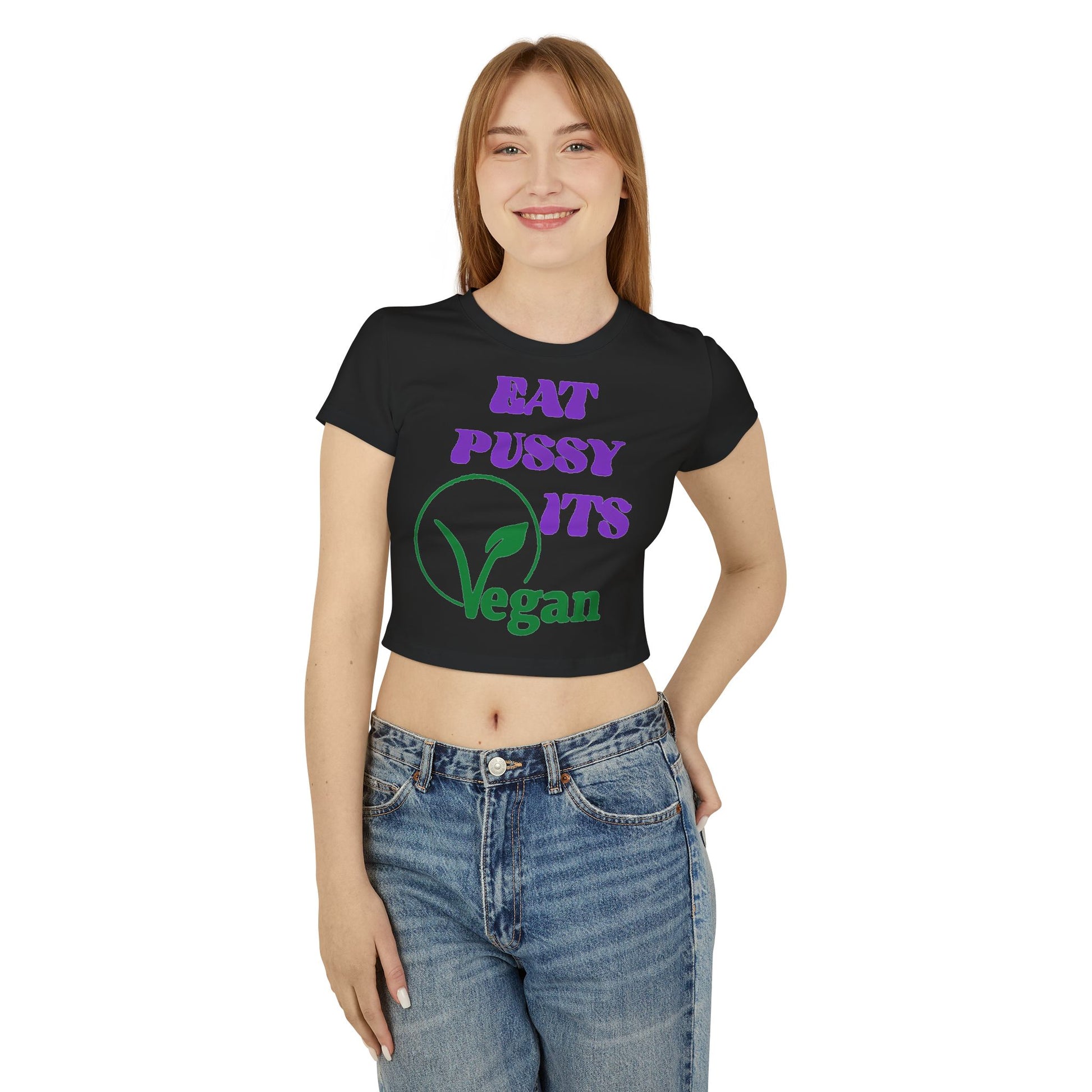 Charming model showcasing a black cropped t-shirt with a striking vegan-themed slogan, merging fashion-forward style with playful messaging.