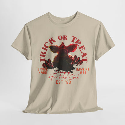 Unisex Hellfire Club graphic t-shirt featuring a striking Demogorgon design, adorned with the text 'TRICK OR TREAT' and other nostalgic elements from the Stranger Things series, perfect for Halloween celebrations.
